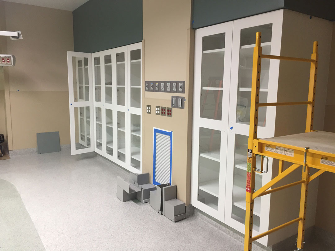 Shield Acrylic solid surface medical storage cabinets in cath lab with fixed and adjustable shelving