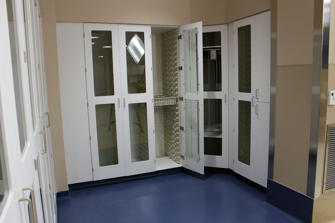 White Acrylic solid surface specialty medical storage cabinets, including high density storage shelving, scope cabinet, and adjustable adjustable shelf models in cardiovascular operating room