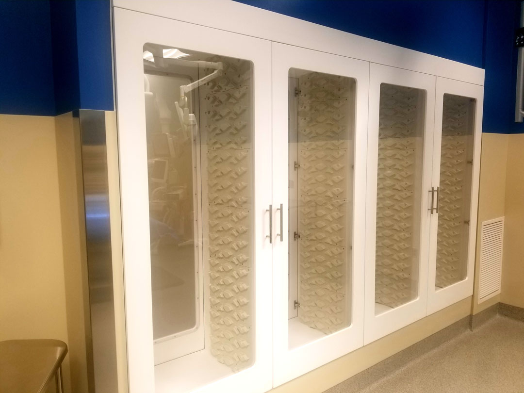Shield Casework Healthcare acrylic solid surface full-height pass-through cabinet shown in operating room with white finish and high density storage